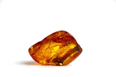 A unique piece of transparent yellow amber on a white background clipart