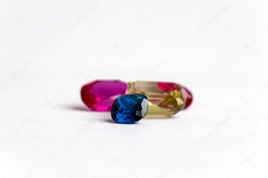 blue sapphire and yellow quartz and pink ruby on a white background