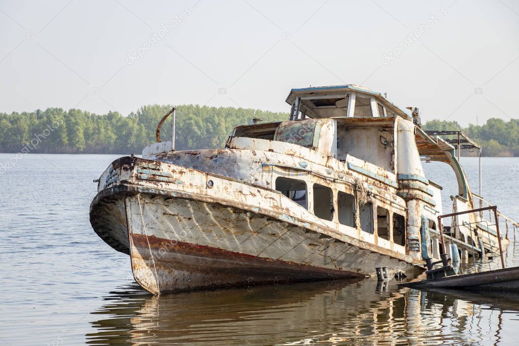 old rusty ship stands in the city river port of the Dnieper