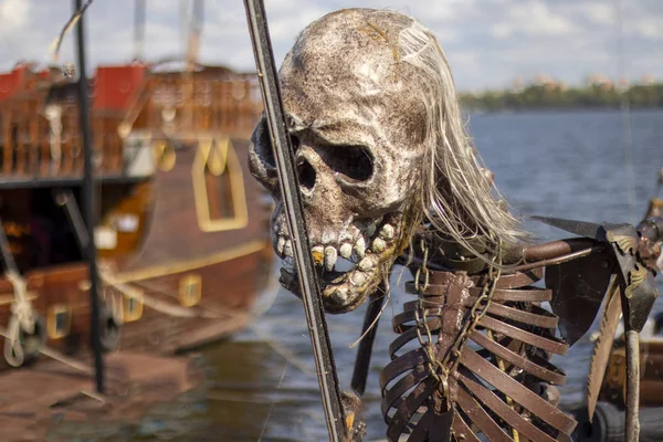 pirate skeleton on the bow of a pleasure pirate ship on the Dnieper River in Ukraine on a summer day