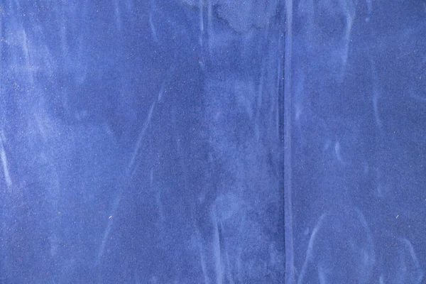 plain dark blue fabric made of artificial materials as a wallpaper