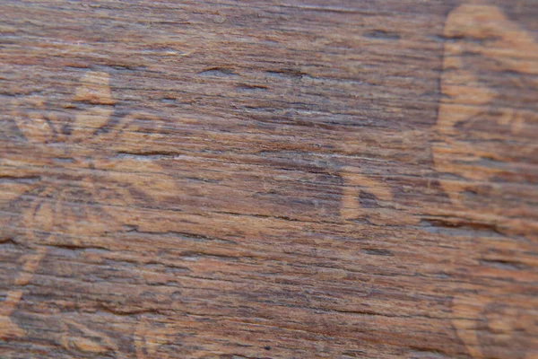 old drawing carved on a wooden chair as a background macro