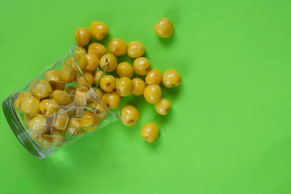 Yellow Cherries Glass Green Table — Stok fotoğraf