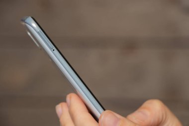 phone in the hands of a girl on a blurry background