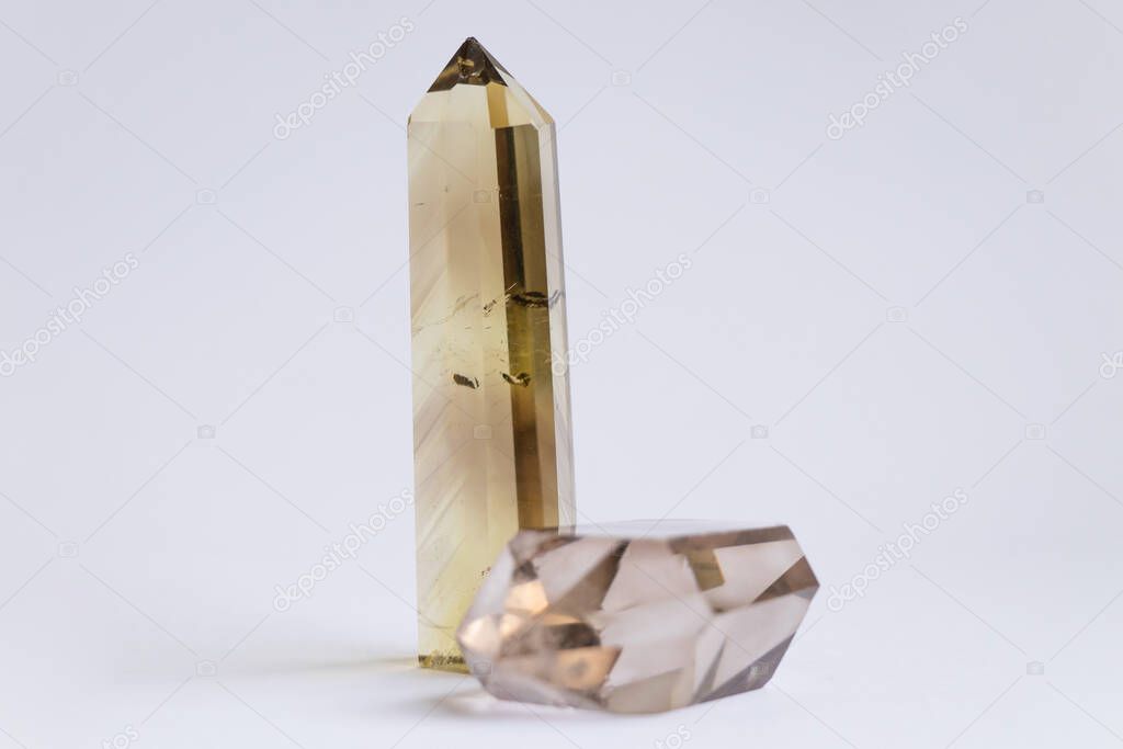 two natural quartz crystals on a white background