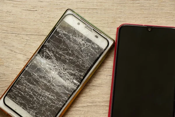 mobile phone and broken tempered glass on an isolated background, glass replacement