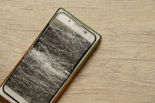 mobile phone and broken tempered glass on an isolated background, glass replacement