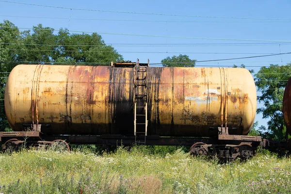 old decommissioned tank for oil transportation stands on the railway