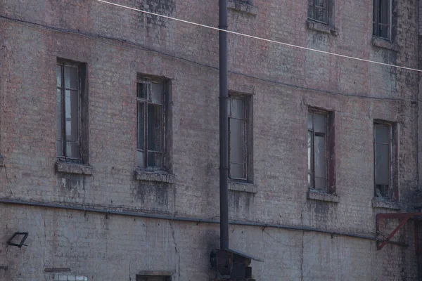 wall with windows of an old non-working factory in ukraine in the city of dnipro