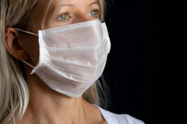 ukrainian girl in medical mask portrait on dark background