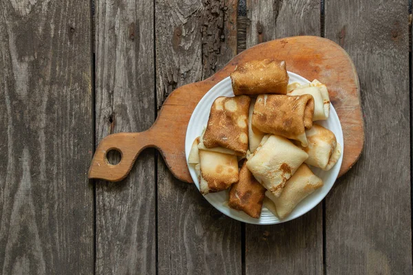 stock image wrapped pancakes on a plate for breakfast are on the table in the kitchen, pancakes for breakfast