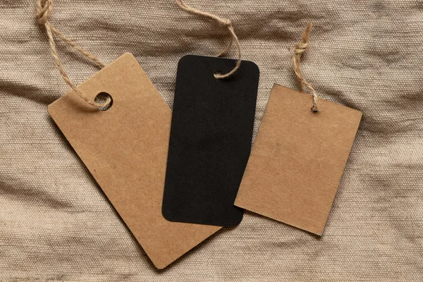 Üç etiket iki kahverengi ve bir siyah bej kumaş üzerinde tasarım için model olarak yatar.