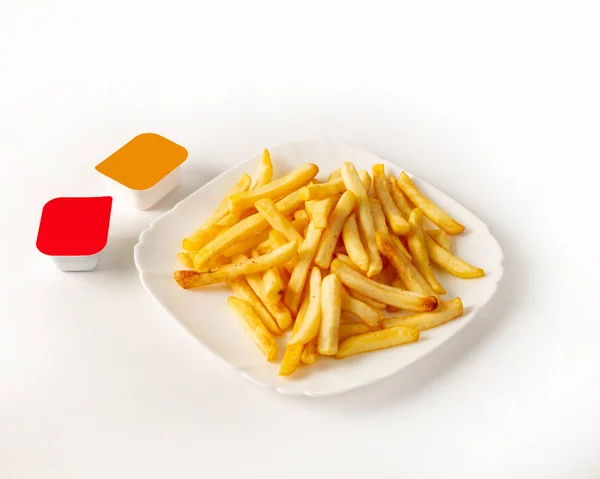 French fries on a plate with two kinds of sauce on the left — Stock Photo, Image