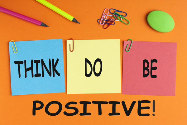 THINK DO BE POSITIVE written on written on color notes with and office supplies.