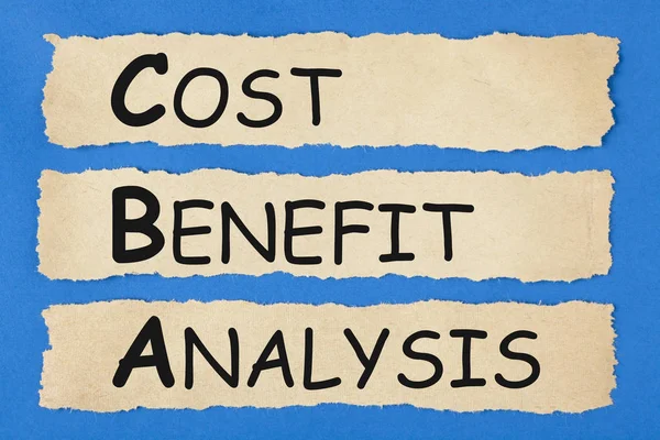 Cost-Benefit Analysis (CBA) written on old torn paper on blue background. Business concept.