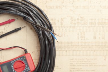 Selective focus of lectric wire cable on electrical diagram background. clipart