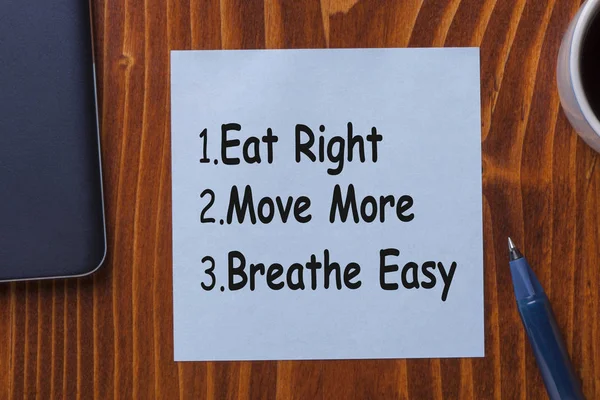 Eat Right, Move More, Breathe Easy written on note. Diet and Fitness Advice.