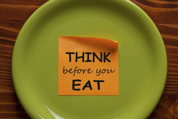 Think Before You Eat written on sticky note on the green plate. Health Tip.