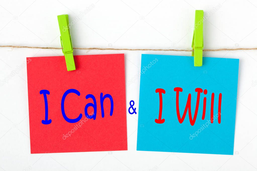 I can and I will written on color notes with wooden pinch. Motivational concept