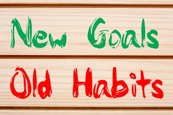 New Goals vs Old Habits written on wood wall decor. Business concept.
