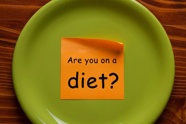 Are you on a diet written on note in plate. Dieting concept.