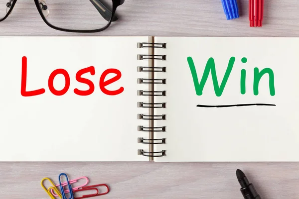 Win Or Lose written on notebook with marker pen. Business Concept.