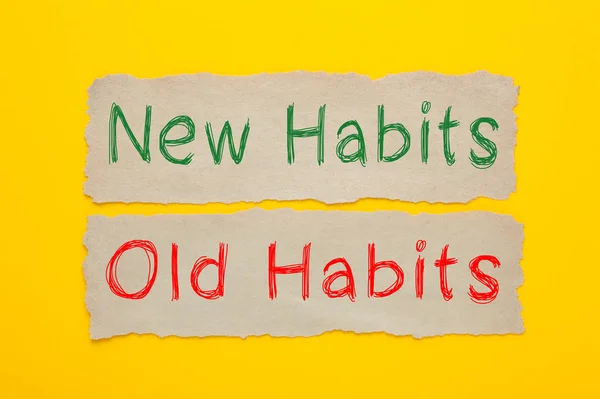 New Habits and Old Habits written on old paper on yellow background.