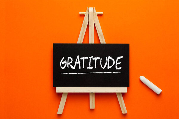 Gratitude written on blackboard on tripod with chalk. Gratitude Practice.