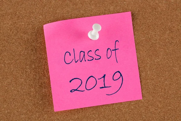 Class of 2019 text on red note pinned on cork board. Educational concept