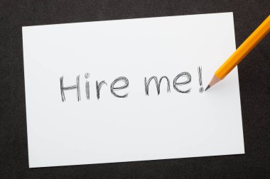 Hire me written with pencil on  white sheet. Business Concept
