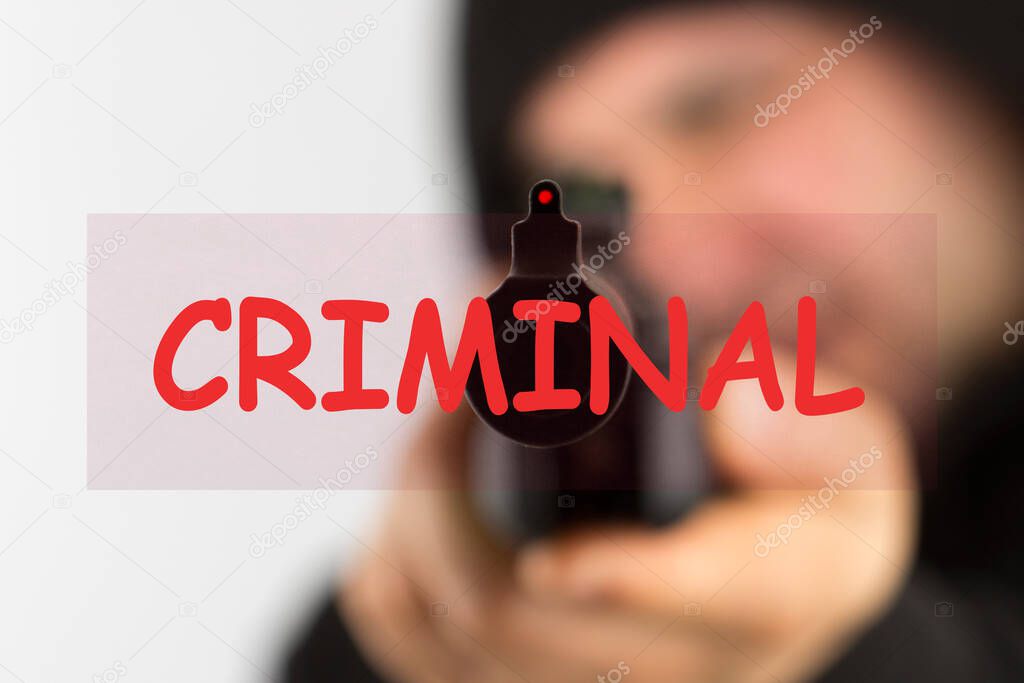 The word criminal over man with gun background