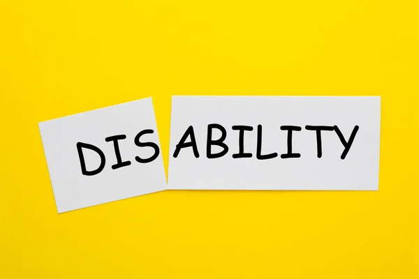 Changing the word disability to ability on a white sheet.