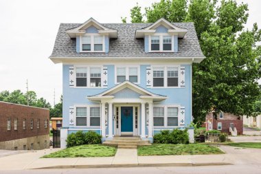 Light blue single family home in urban development