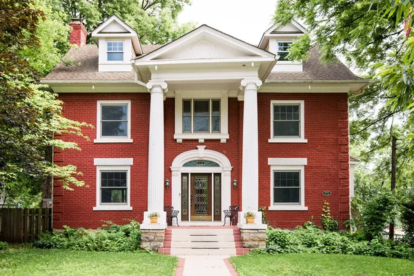 Historic brick home with large white pillars