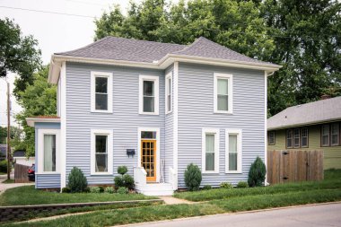 Flat fronted colonial home with bright yellow door