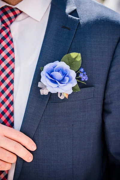 Violey bloemen boutonniere tegen marine blauwe blazer — Stockfoto