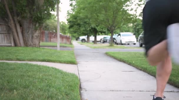 Young Caucasian Man Jogs Sidewalk Summer Morning — Stock Video