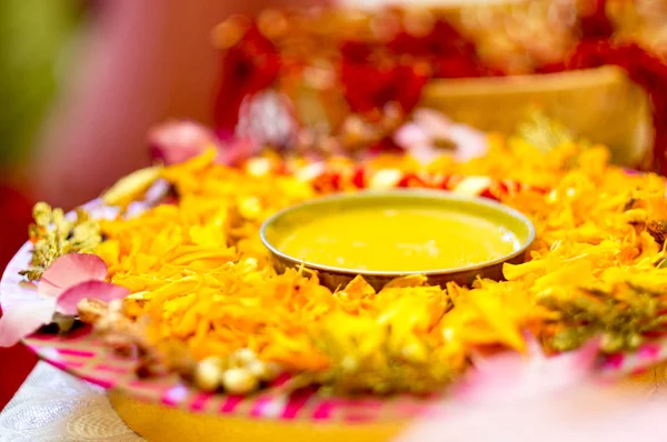 Traditional Haldi turmeric kept on a flower plate for the hindu marriage ceremony