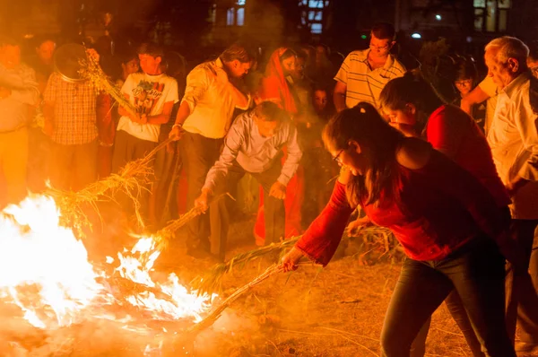 Menschen sammeln gekochtes Getreide und Kohle am traditionellen Holi-Lohri-Lagerfeuer in Indien — Stockfoto