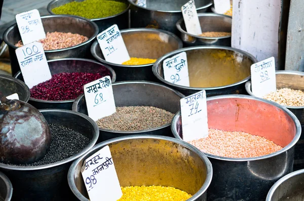 Pulses placed in steel drums with price tags ready for sale