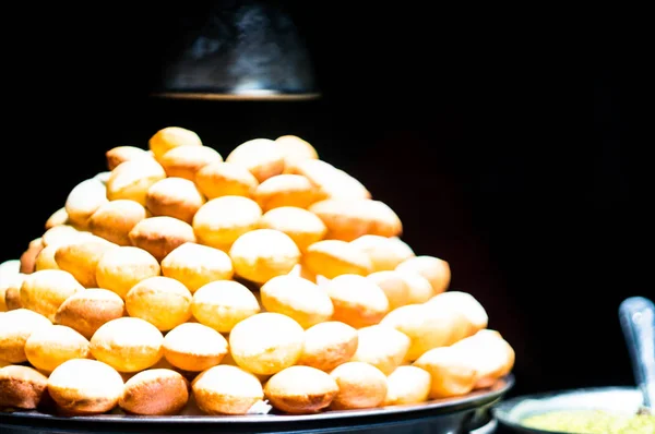 Pani Puri stall with lots of gol gappe placed in pile