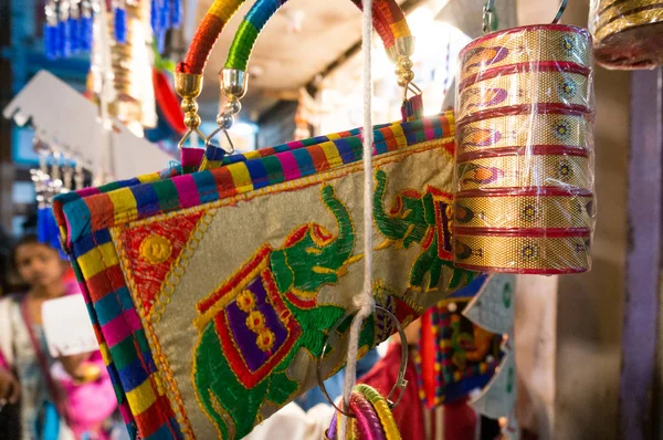 Colorful handbags, bangles, accessories, and decoration items hanging in a shop