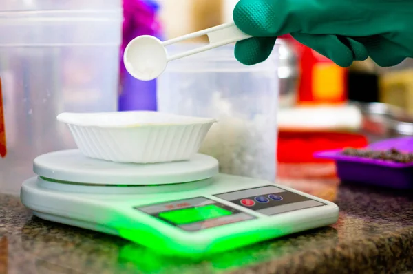 Lye caustic soda being measured out on weighing scale for making soap — Stock Photo, Image