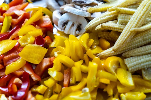 Mix of multicolored vegetables with mushrooms, baby corn, yellow chilli peppers and more cur for a vegetarian dish