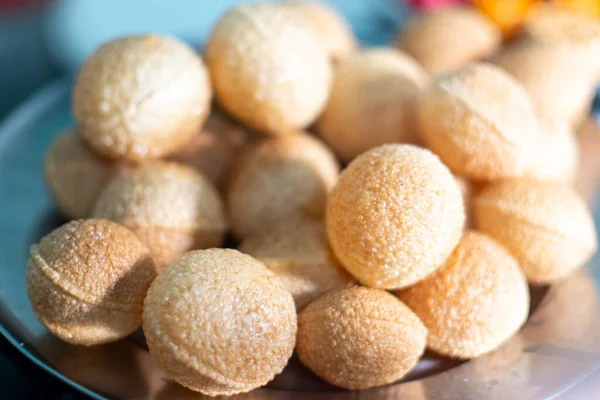 Shot of north indian street food gol gappe pani puri or puchke being fried from dough in hot oil to make them round hollow golden ball spheres — Stok Foto