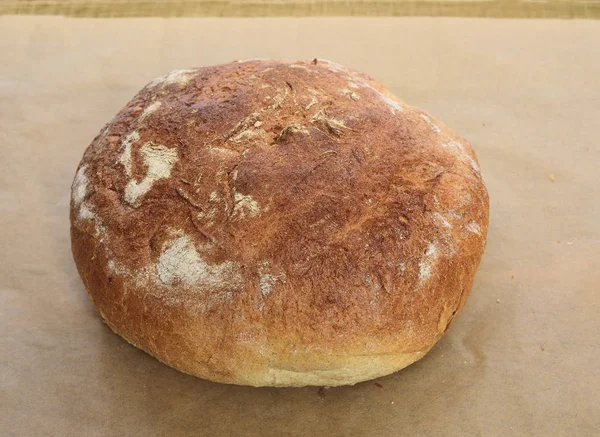 Closeup Fresh Homemade Bread Golden Crispy Crust Parchment Baking Wooden — Stock Photo, Image