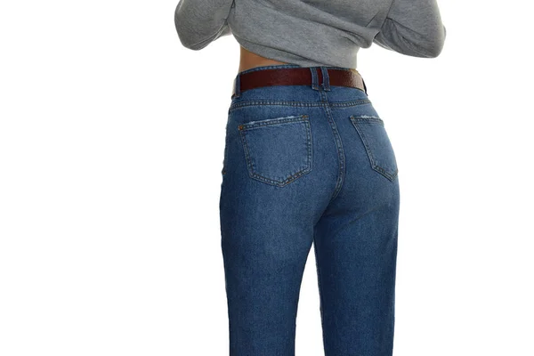 Woman in high waist blue jeans  and gray sweatshirt isolated on white background