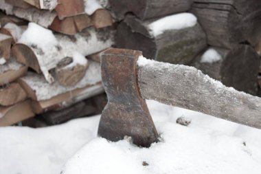 Axe on the background of birch wood and log bath