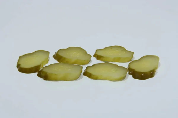 Pickled cucumbers, sliced on a board