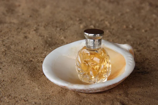 Faceted Perfume Bottle on Sea Sand
